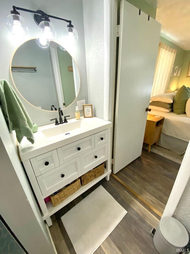 138 N Harrison St, Bloomfield, IN 47424 - bathroom with wood finished floors and vanity