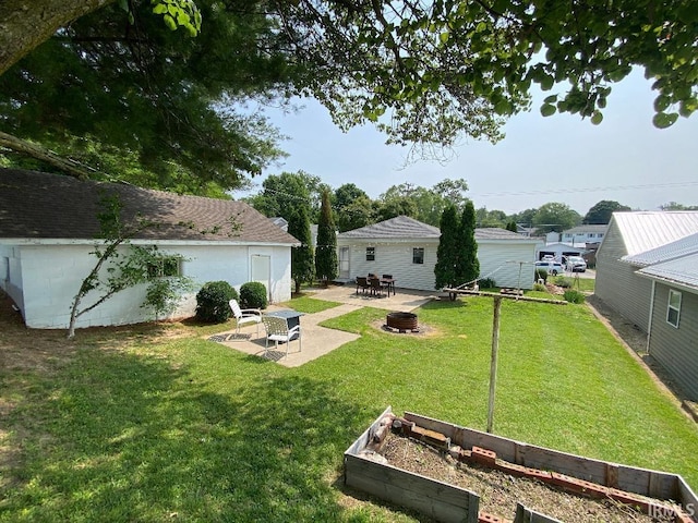 138 N Harrison St, Bloomfield, IN 47424 - view of green lawn with a fire pit, a vegetable garden, and a patio area
