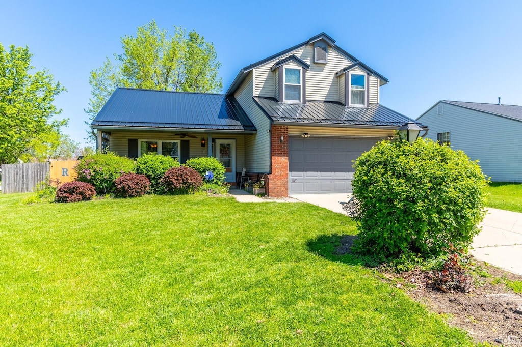3630 Three Oaks Dr, Fort Wayne, IN 46809 - view of front of home featuring concrete driveway, an attached garage, a standing seam roof, metal roof, and brick siding