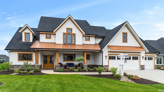 5272 Greyson Heights Dr, Auburn, IN 46706 - modern inspired farmhouse featuring covered porch, a standing seam roof, french doors, a front lawn, and board and batten siding