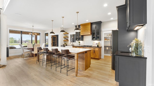 5272 Greyson Heights Dr, Auburn, IN 46706 - kitchen featuring freestanding refrigerator, tasteful backsplash, premium range hood, light wood finished floors, and recessed lighting