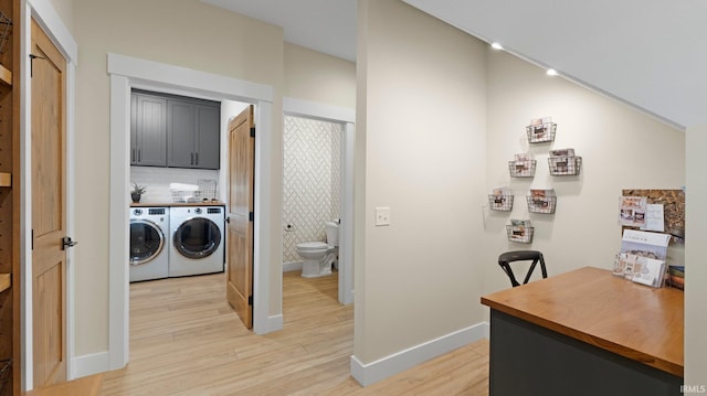 5272 Greyson Heights Dr, Auburn, IN 46706 - laundry area with washing machine and clothes dryer, light wood-style floors, cabinet space, baseboards, and a desk