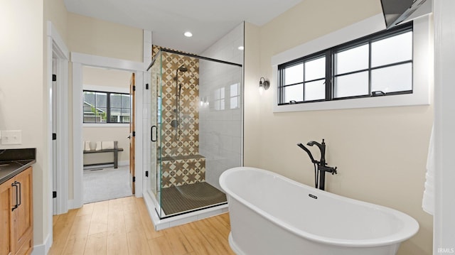 5272 Greyson Heights Dr, Auburn, IN 46706 - full bath featuring a freestanding tub, wood finished floors, a stall shower, vanity, and recessed lighting