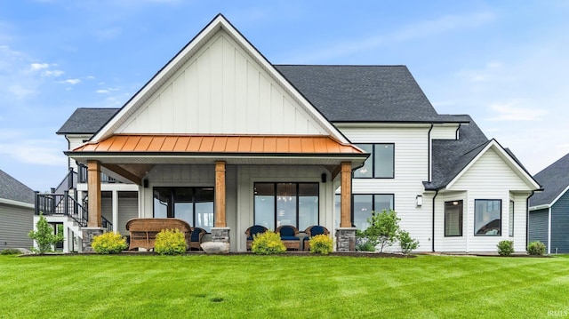 5272 Greyson Heights Dr, Auburn, IN 46706 - rear view of property featuring board and batten siding, a shingled roof, a standing seam roof, and a yard