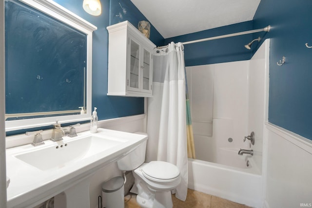 16316 Thunderbird Rd, Huntertown, IN 46748 - bathroom with shower / tub combo, toilet, a wainscoted wall, a sink, and tile patterned flooring