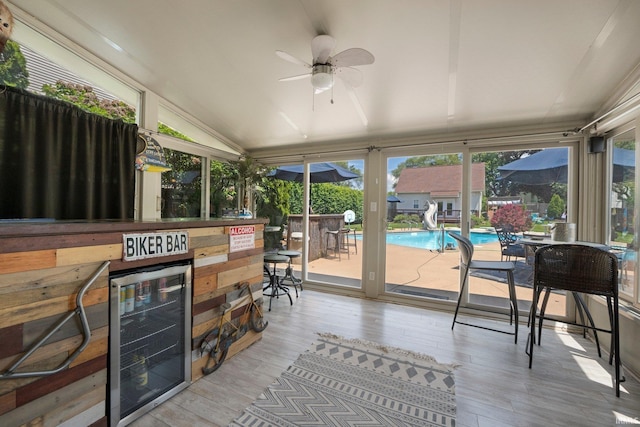 16316 Thunderbird Rd, Huntertown, IN 46748 - sunroom / solarium featuring beverage cooler, lofted ceiling, wood finished floors, and a wooden deck
