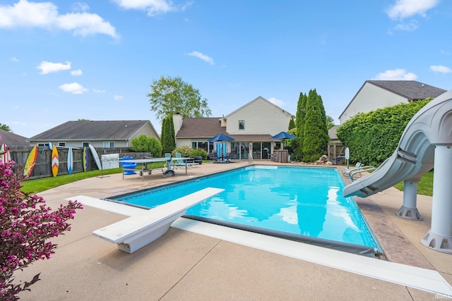 16316 Thunderbird Rd, Huntertown, IN 46748 - view of swimming pool with a water slide, a diving board, a patio area, and a fenced backyard