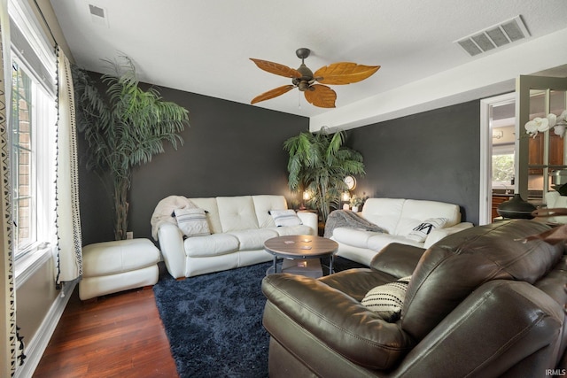 16316 Thunderbird Rd, Huntertown, IN 46748 - living area featuring an accent wall, a ceiling fan, wood finished floors, and baseboards
