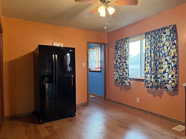 209 Acton St, Loogootee, IN 47553 - kitchen featuring black refrigerator with ice dispenser, a ceiling fan, wood finished floors, and baseboards