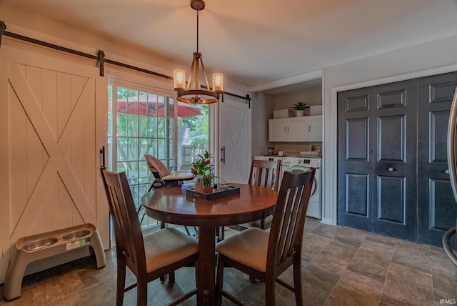 36 Jacks St, Gas City, IN 46933 - dining area featuring a barn door, washer / clothes dryer, a chandelier, and stone finish flooring