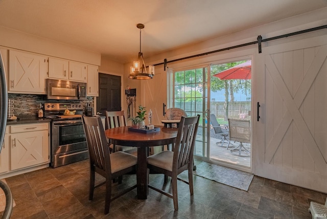 36 Jacks St, Gas City, IN 46933 - dining room with a barn door, stone finish floors, and a chandelier