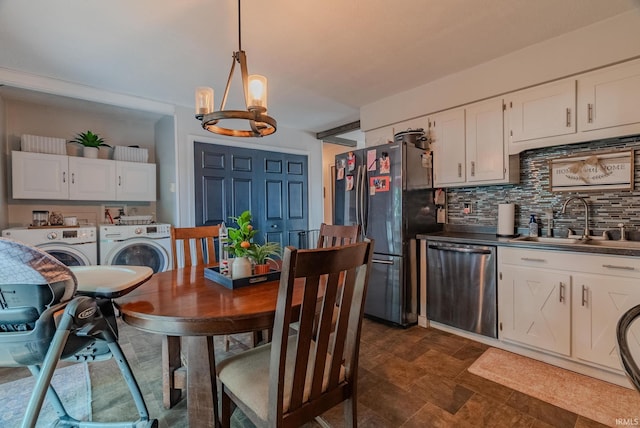 36 Jacks St, Gas City, IN 46933 - dining room with washing machine and dryer, a chandelier, and stone finish flooring