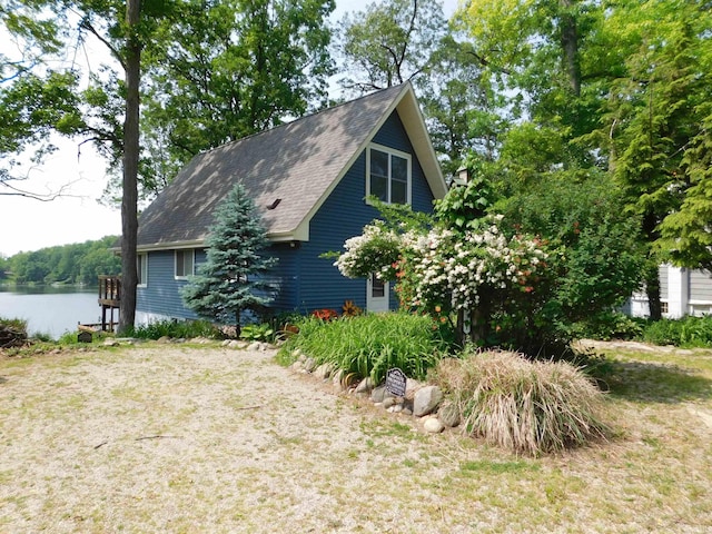 9381 E Promontory Point Dr, Syracuse, IN 46567 - view of side of property with a water view and a shingled roof