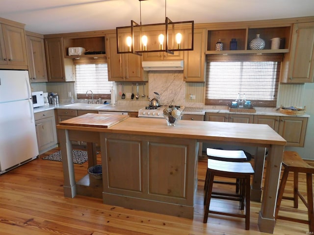 9381 E Promontory Point Dr, Syracuse, IN 46567 - kitchen with white appliances, wood counters, under cabinet range hood, a sink, and open shelves