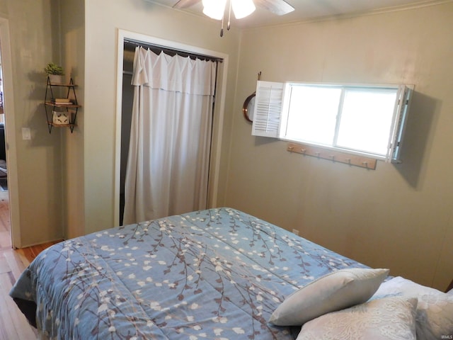 9381 E Promontory Point Dr, Syracuse, IN 46567 - bedroom with wood finished floors and ceiling fan