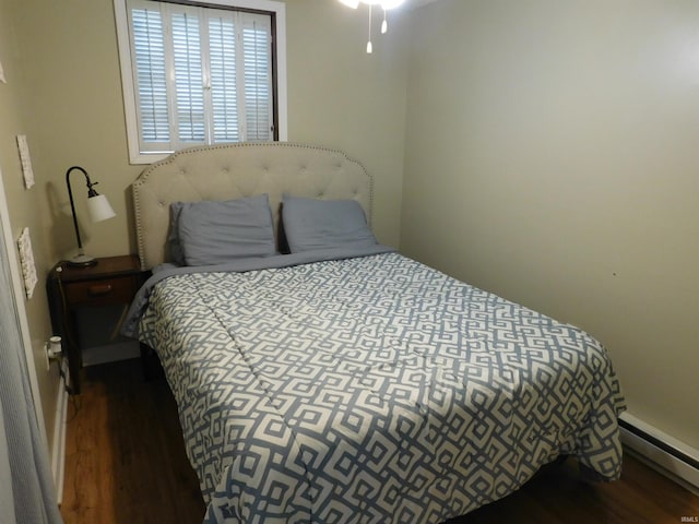 9381 E Promontory Point Dr, Syracuse, IN 46567 - bedroom with a baseboard heating unit and wood finished floors