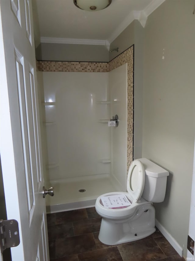 3910 Stringtown Rd, Evansville, IN 47711 - full bathroom with crown molding, toilet, a shower stall, stone finish flooring, and baseboards