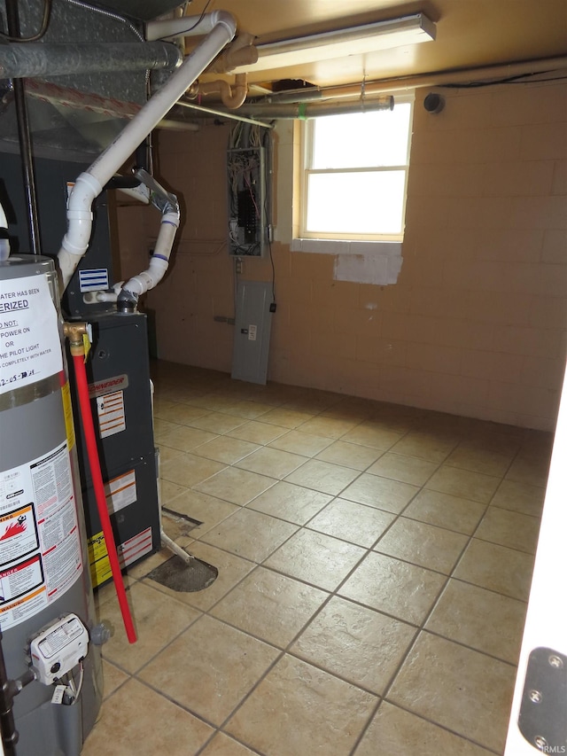 3910 Stringtown Rd, Evansville, IN 47711 - basement featuring gas water heater and light tile patterned flooring