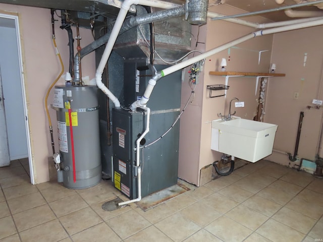 3910 Stringtown Rd, Evansville, IN 47711 - utility room featuring water heater, a sink, and heating unit