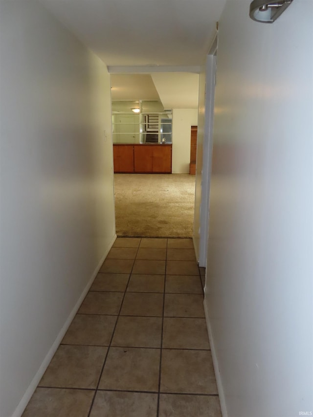 3910 Stringtown Rd, Evansville, IN 47711 - hallway featuring light tile patterned flooring, light carpet, and baseboards