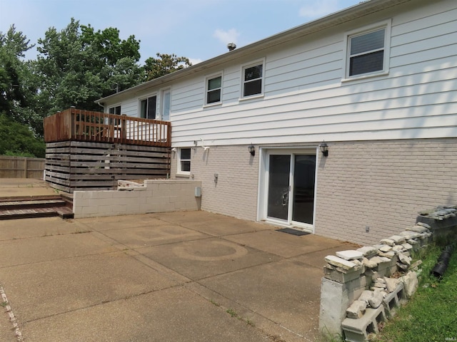3910 Stringtown Rd, Evansville, IN 47711 - back of house with a wooden deck, a patio, and brick siding