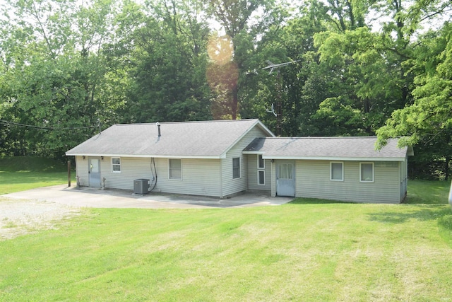 473 Gunsmith School Rd, Bedford, IN 47421 - ranch-style home featuring a front lawn, a patio area, central air condition unit, and roof with shingles