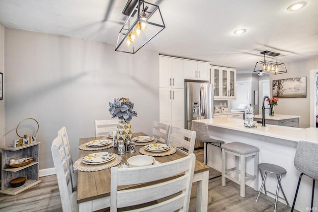 55705 Sichuan Dr, Osceola, IN 46561 - dining area featuring light wood-style flooring, recessed lighting, and baseboards