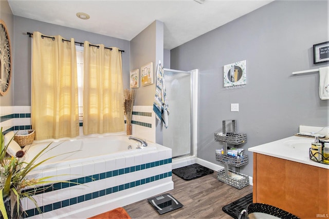 55705 Sichuan Dr, Osceola, IN 46561 - bathroom featuring a bath, a stall shower, vanity, and wood finished floors