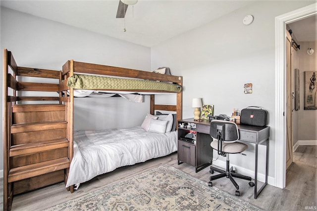 55705 Sichuan Dr, Osceola, IN 46561 - bedroom featuring wood finished floors, an office area, baseboards, and ceiling fan