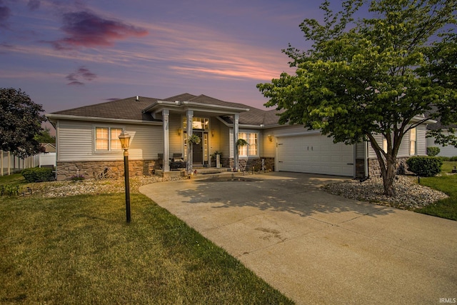 55705 Sichuan Dr, Osceola, IN 46561 - view of front facade featuring stone siding, concrete driveway, an attached garage, a shingled roof, and a front yard