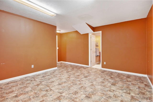 55705 Sichuan Dr, Osceola, IN 46561 - empty room featuring baseboards, stone finish floors, and a textured ceiling