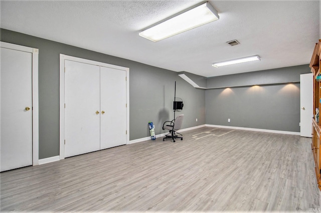 55705 Sichuan Dr, Osceola, IN 46561 - below grade area with wood finished floors, baseboards, and a textured ceiling