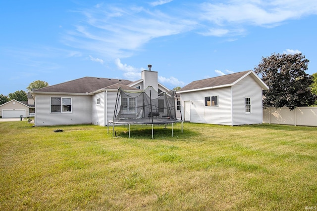 55705 Sichuan Dr, Osceola, IN 46561 - rear view of property featuring a trampoline, an outbuilding, and a chimney