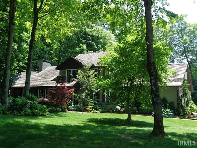 1365 W 15th St, Jasper, IN 47546 - view of front of house featuring a front lawn and a chimney