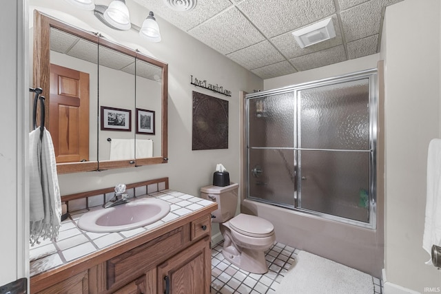 1365 W 15th St, Jasper, IN 47546 - bathroom with vanity, shower / bath combination with glass door, toilet, tile patterned flooring, and a drop ceiling