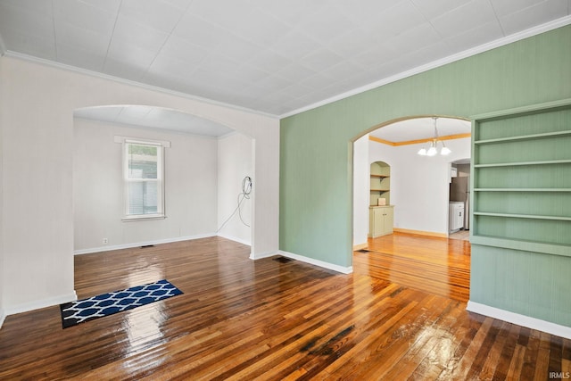 204 N W St, Attica, IN 47918 - unfurnished room with wood-type flooring, crown molding, arched walkways, a chandelier, and baseboards