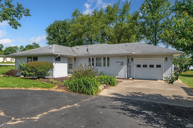 4294 E Defreese Rd, Syracuse, IN 46567 - ranch-style home featuring a garage and asphalt driveway