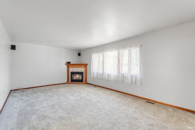 4294 E Defreese Rd, Syracuse, IN 46567 - unfurnished living room with carpet flooring, baseboards, and a tiled fireplace