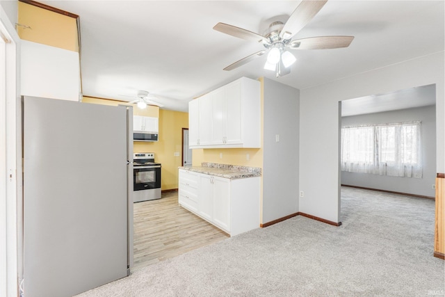4294 E Defreese Rd, Syracuse, IN 46567 - kitchen featuring appliances with stainless steel finishes, a ceiling fan, white cabinetry, light countertops, and light colored carpet