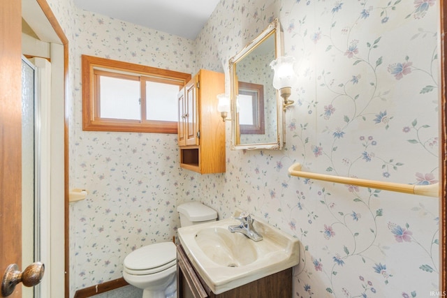 4294 E Defreese Rd, Syracuse, IN 46567 - full bath with toilet, vanity, a shower with door, and wallpapered walls