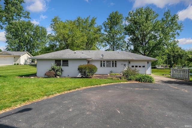 4294 E Defreese Rd, Syracuse, IN 46567 - view of front of home featuring driveway, an attached garage, and a front lawn