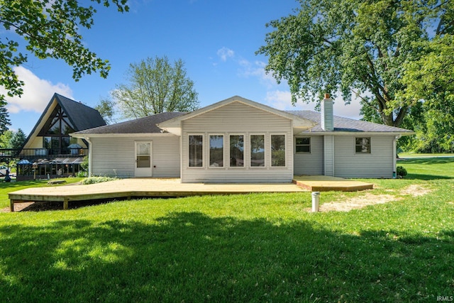 4294 E Defreese Rd, Syracuse, IN 46567 - back of house with a chimney, a yard, and a deck
