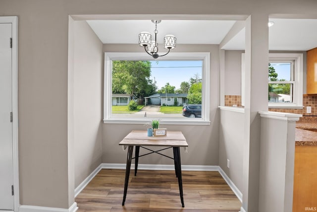 1008 Beck Ln, Lafayette, IN 47909 - dining room featuring wood finished floors, a chandelier, and baseboards