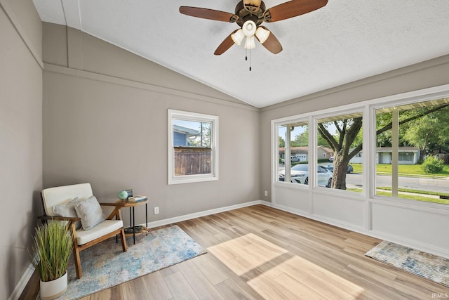 1008 Beck Ln, Lafayette, IN 47909 - living area featuring vaulted ceiling, wood finished floors, a textured ceiling, ceiling fan, and baseboards