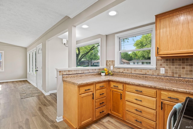 1008 Beck Ln, Lafayette, IN 47909 - kitchen with backsplash, lofted ceiling, light wood finished floors, light countertops, and baseboards