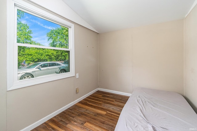 17016 Ruthie Ave, South Bend, IN 46635 - unfurnished bedroom featuring lofted ceiling, dark wood-style floors, and baseboards