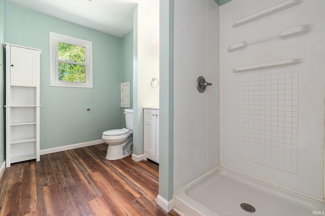 17016 Ruthie Ave, South Bend, IN 46635 - bathroom with toilet, wood finished floors, a shower, vanity, and baseboards