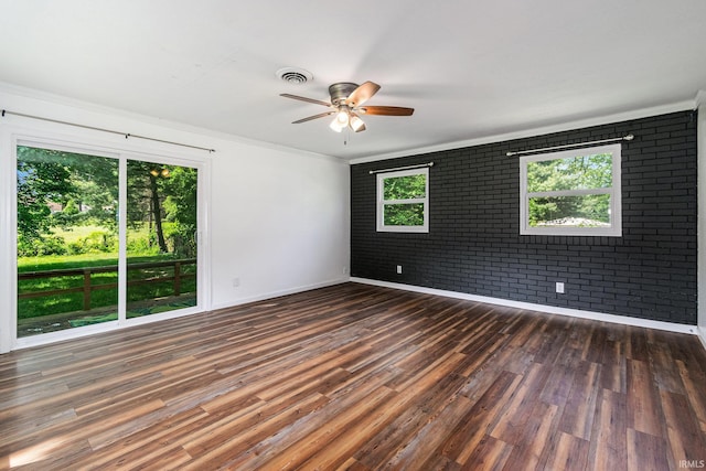 17016 Ruthie Ave, South Bend, IN 46635 - empty room with brick wall, dark wood-type flooring, a ceiling fan, baseboards, and ornamental molding
