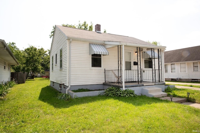 2331 N 24th St, Lafayette, IN 47904 - view of front of home featuring a front yard, a chimney, and covered porch