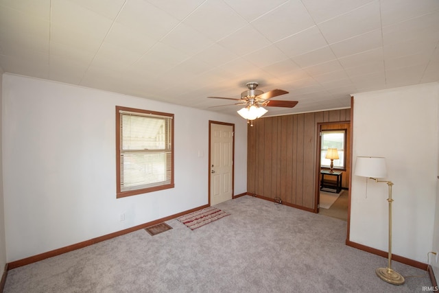 2331 N 24th St, Lafayette, IN 47904 - unfurnished room with light colored carpet, ceiling fan, baseboards, and wooden walls